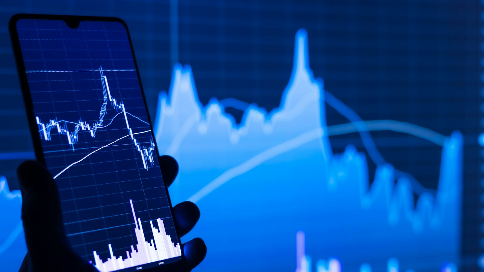 Phone in front of a price chart