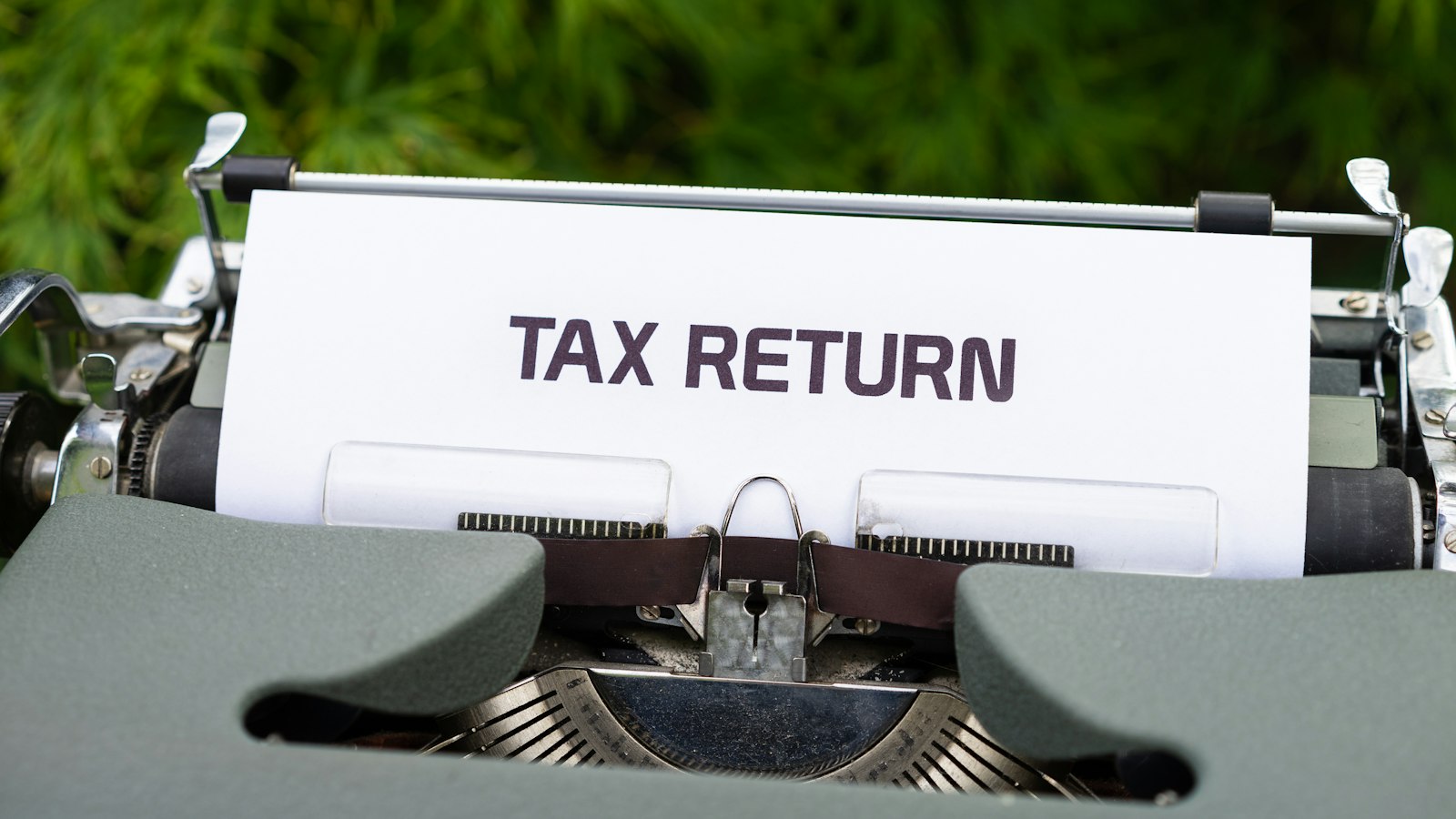 Typewriter with a sheet reading Tax Return