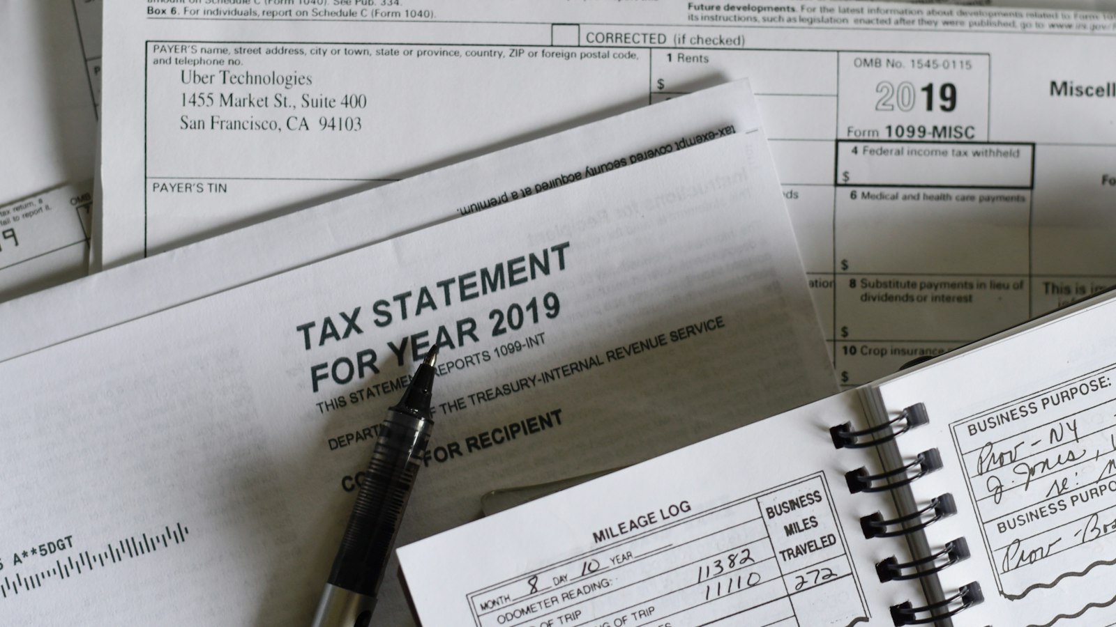 Pen resting on printed IRS tax forms